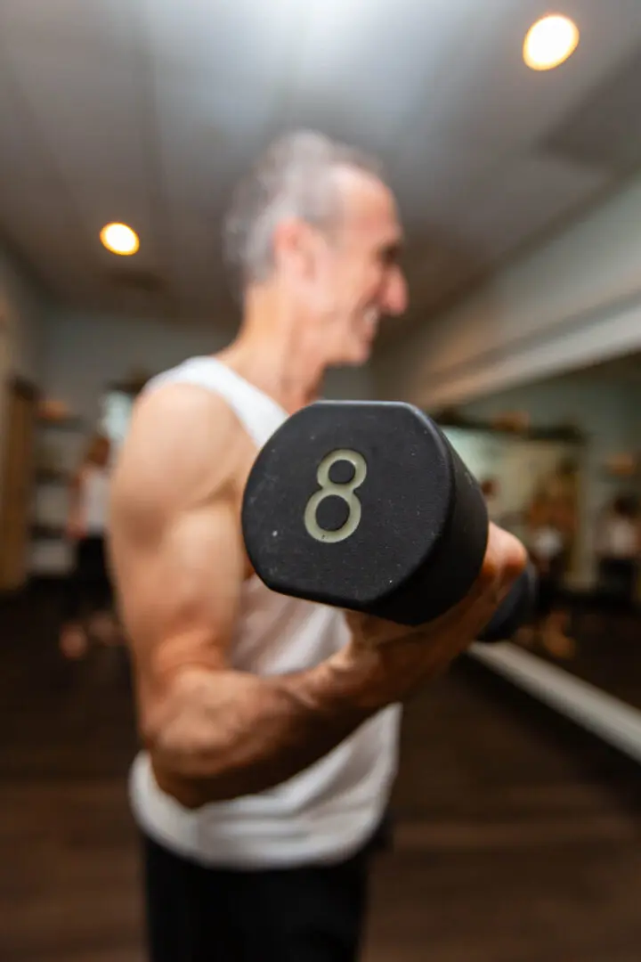 Person lifting 8-pound dumbbell in gym