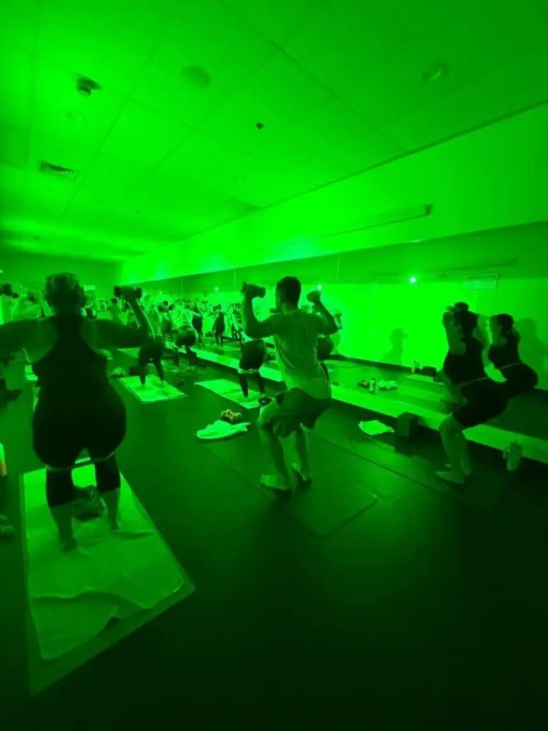 Group fitness class performing squats in studio