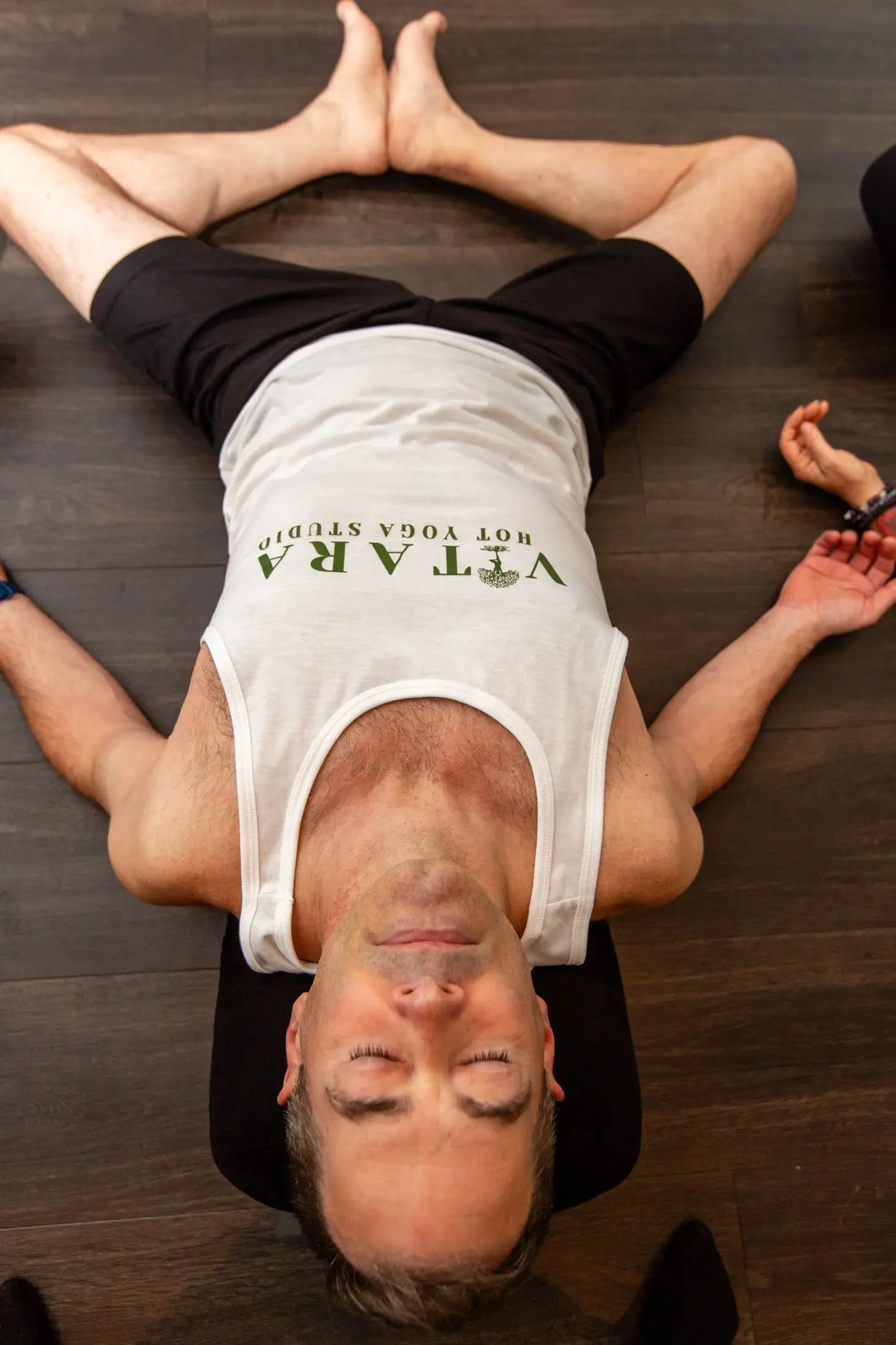 Vitara Hot Yoga teacher helping students in Seacoast New Hampshire